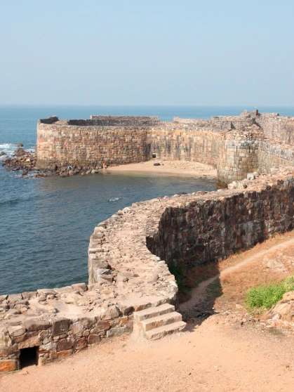 A man taking care of his boat on the beach in Dapoli