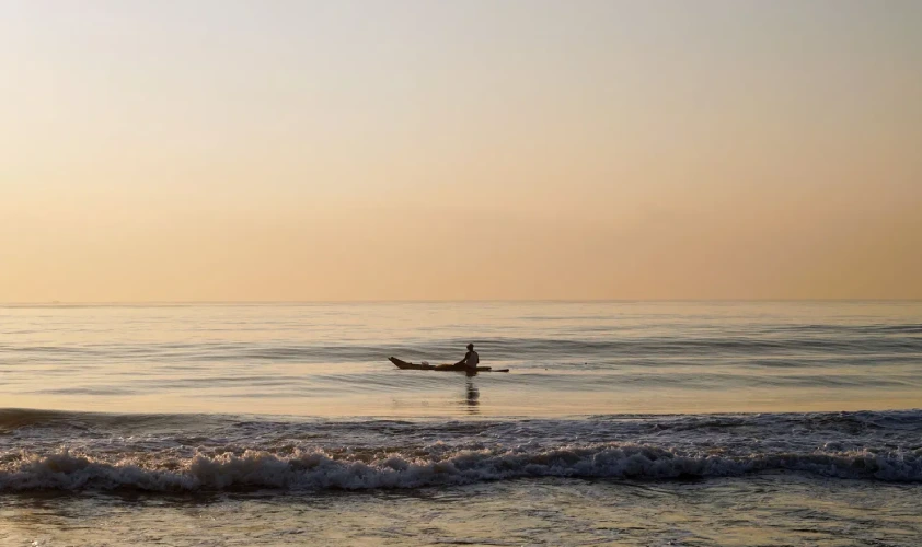Lotus Eco beach resort, one person on a boat in the sea