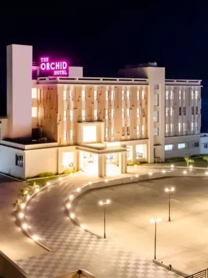 Facade image of The Orchid Hotel, Jamnagar in the night with the lights on