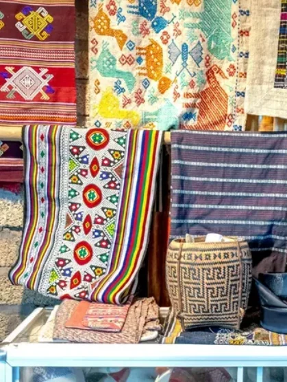 Colorful handmade traditional fabrics on display in a shop