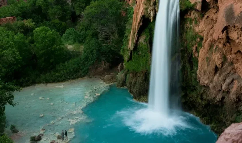 A waterfall among large mountains