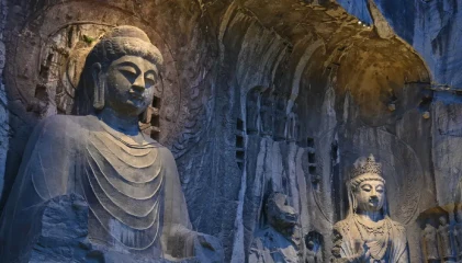 Visitors exploring interiors of Karla Caves – meditation hall and carvings