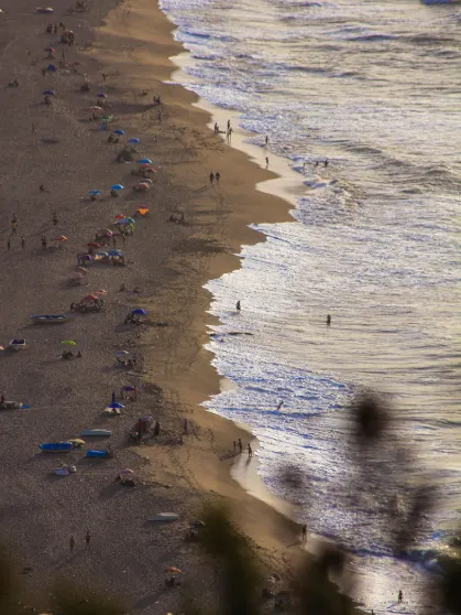 a serene beach with clear blue water and backdrop of the sky