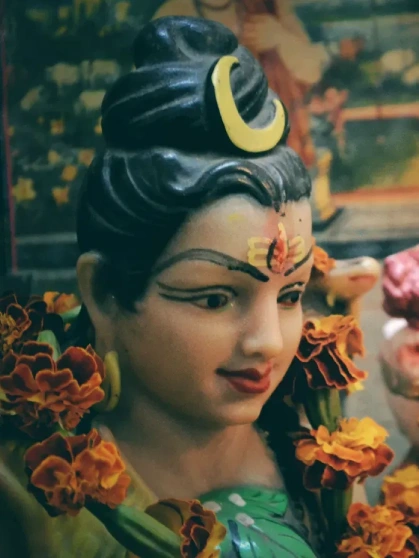 Mud idol of Lord Ganesha placed near a tree