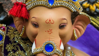 Idol of Lord Ganesha with a red and blue crown