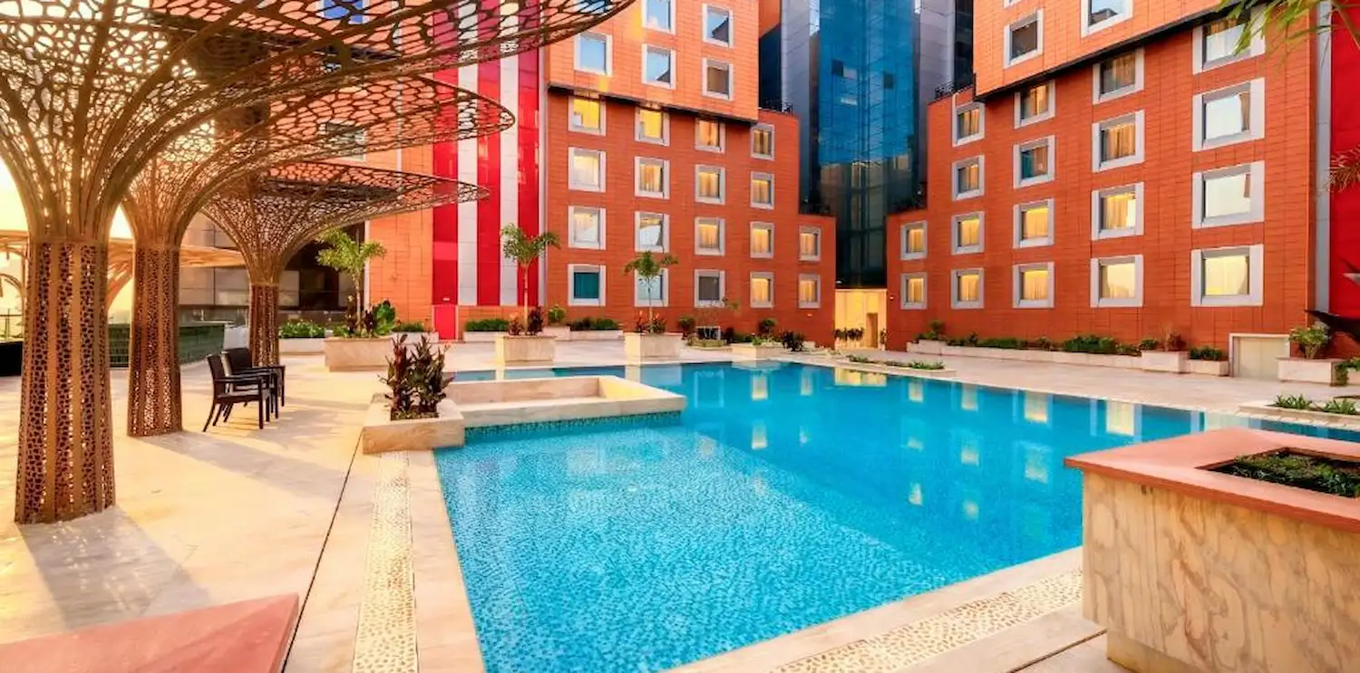 Swimming pool and lawn at The Orchid Hotel Pune Balewadi