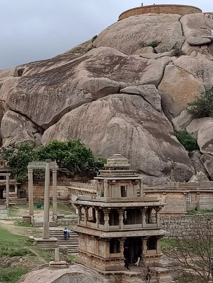 An ancient Indian temple surrounded by trees during daytime