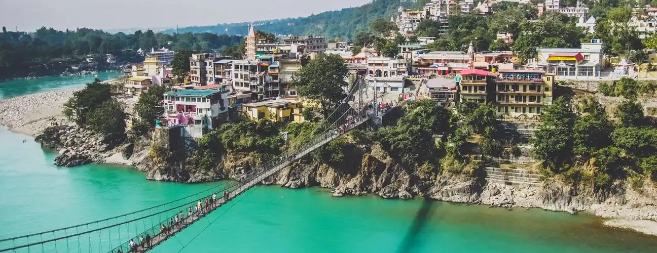 Ganga river flowing through Rishikesh with Himalayan foothills in the background