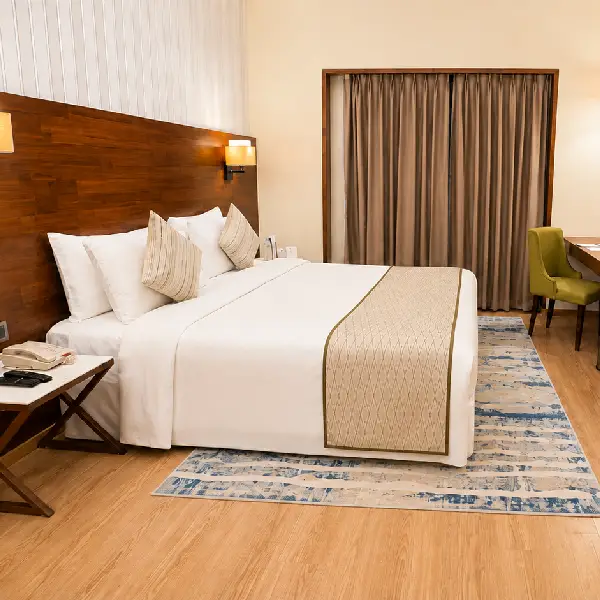 Hotel Room with Bed Hotel room with bed and dark wood headboard