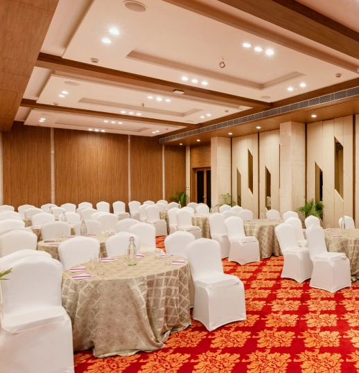Elegant banquet setup for events at Orchid Hotel Jamnagar Elegant Banquet Hall Setup at Orchid Hotel Jamnagar for Weddings & Parties