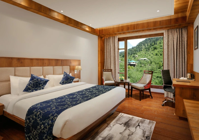 Deluxe Room at Orchid Hotel Manali featuring breathtaking mountain views and modern amenities