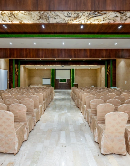 Conference Hall in Panchgani – Corporate Events at Orchid Hotel Conference hall with podium, marble flooring, and projector screen at Orchid Hotel Panchgani for corporate events