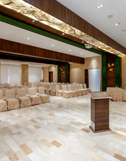 Conference Hall in Panchgani – Corporate Events at Orchid Hotel Conference hall with podium, marble flooring, and projector screen at Orchid Hotel Panchgani for corporate events