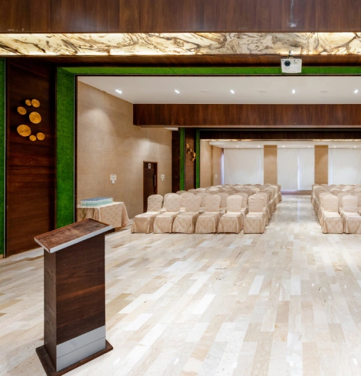 Meadows Event Venue Panchgani – Book Wedding & Meeting Hall Meadows event venue with podium and covered seating at Orchid Hotel Panchgani for weddings and meetings