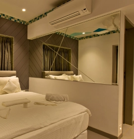 Stylish glass wall decor in Dew Drop Room at Orchid Hotel Panchgani offering elegant ambience