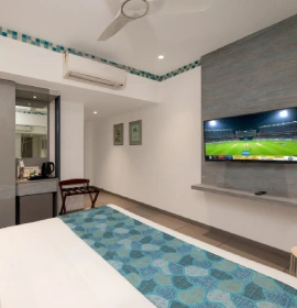 Dew Drop queen bed room with flat screen TV and AC at Orchid Hotel Panchgani
