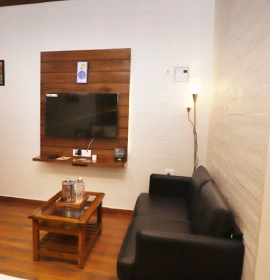 Forest Tent interior with sofa set at Orchid Hotel Panchgani, perfect for family or romantic getaway