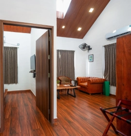 Exterior view of Tree House Suite wooden cabin surrounded by tall eucalyptus trees at Orchid Hotel Panchgani