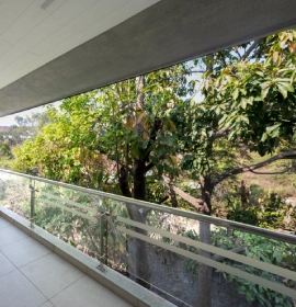 Strawberry Club Room private balcony with glass railing and panoramic lush green valley view at Orchid Hotel Panchgani