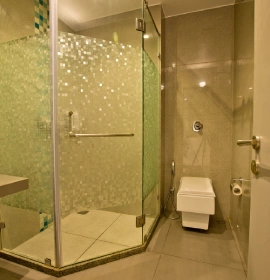 Modern shower in Wooden Cottage Suite at Orchid Hotel Panchgani, ideal for families and couples
