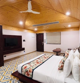 Prakruti Deluxe Room – Comfortable Hotel Stay with Riverside Views near Ganga, Rishikesh Elegant interiors of Prakruti Deluxe Room at Orchid Hotel Rishikesh – Resort near Byasi